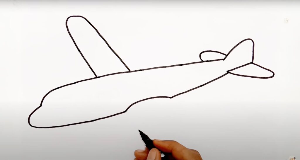 A man draws first wing of the airplane