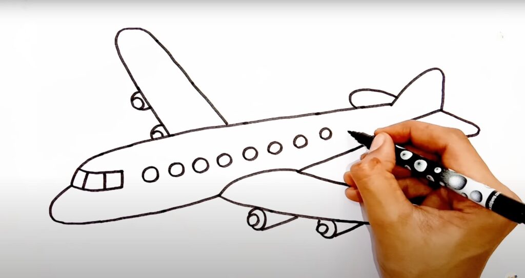 A man draws final details airplane